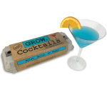 Cocktail gift set with a blue drink in a martini glass and an egg carton box