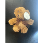 Brown teddy bear with a ribbon and tag