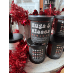 Black candles with heart labels surrounded by red tinsel garland