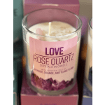 Pink rose quartz candle in a glass jar with a label