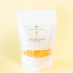 White candy bag labeled Champagne Gummies on a pale yellow background