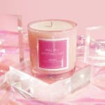 Pink glass candle in a clear jar with a Malibu Apothecary label