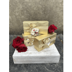 Gold gift boxes with red roses on a wooden base