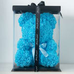 Blue rose teddy bear in a clear gift box with a black ribbon
