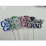 Glitter graduation cake toppers with mortarboard caps and "Congrats Grad" text