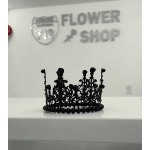 Black decorative crown on a white counter