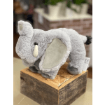 Plush gray elephant toy standing on a wooden block