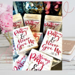 Stack of decorative books with "Always Pray" and "Never Give Up" text