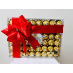 Box of gold-wrapped chocolates tied with a large red ribbon