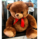Brown teddy bear with a red ribbon bow