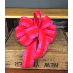 Bright pink ribbon bow on a wooden crate