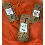 Three plant picks with illustrated greeting cards on orange fabric.