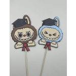 Two cartoon graduation topper picks with smiling faces