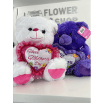 Two plush teddy bears holding heart-shaped Mother's Day pillows