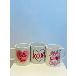 Three white mugs with pink and red love-themed designs