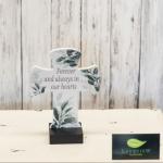 Decorative memorial cross with floral leaf print and the words Forever and always in our hearts
