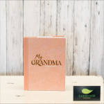 Pink book-shaped gift box labeled "My Grandma" on a white surface