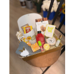 Gift box with tea, cookies, soap, bath items, and a small plush toy