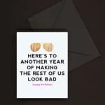 White birthday card with gold sunglasses illustration and bold black text on a dark envelope