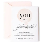 White birthday greeting card reading 'you are remarkable' with a pale pink envelope
