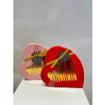 Two heart-shaped chocolate gift boxes tied with yellow ribbons