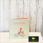 A greeting card with a woman riding a bicycle and the words "Celebrating You."