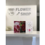 Three floral greeting cards displayed on a shelf