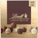 Box of assorted Lindt gourmet chocolate truffles on gold background