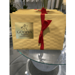 Gold Godiva chocolate gift boxes tied with red ribbon