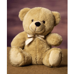 Plush teddy bear with a satin bow sitting against a blurred background