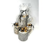 Three patterned mugs wrapped with candy and tied in clear plastic