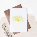 Greeting card with a yellow flower illustration on a brown envelope