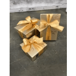 Three gold gift boxes tied with ribbon bows