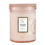 Pink glass candle jar with a lid and label