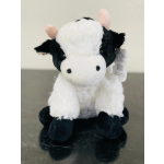 Plush black-and-white cow stuffed animal with a hanging tag