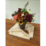 Mixed bouquet with red roses, carnations, and chrysanthemums in a dark vase
