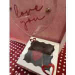 Pink gift box with a clear heart window and glitter hearts