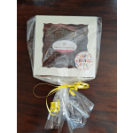 Gift box of homemade fudge wrapped in clear plastic with a birthday sticker.