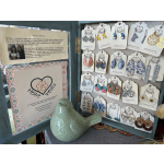 Display case of Heart Petals earrings with a ceramic bird figurine
