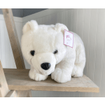 White plush polar bear with a price tag on a wooden shelf