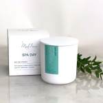 White soy wax candle in a box with green label and sprig of leaves