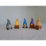 Five small painted gnome figurines lined up on a tabletop