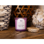 Purple scented candle with a wooden lid on a table