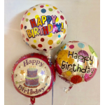 Three birthday balloons with colorful polka dots and cake graphics