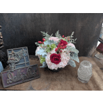 Arrangement of pink hydrangeas and red roses in a low vase