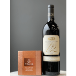 Wine bottle beside a box of gray and smoked salt caramels