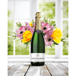 Champagne bottle with pink and yellow flowers arranged around it