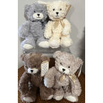 Four plush teddy bears in gray, cream, brown, and beige with ribbon bows