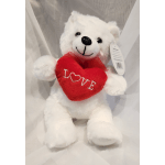 White teddy bear holding a red heart with the word LOVE