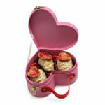 Pink heart-shaped box holding chocolate-covered strawberries